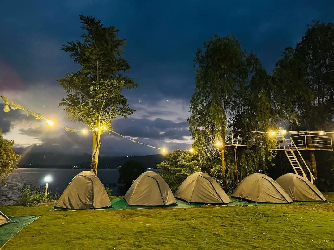 Birthday celebration near Pune, lakeside dome tents glowing under string lights at night