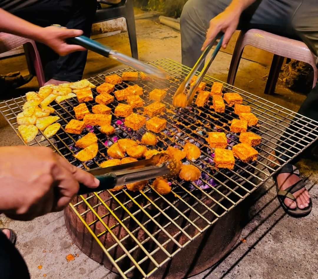 Paneer and veg BBQ sizzling on the grill at the campsite