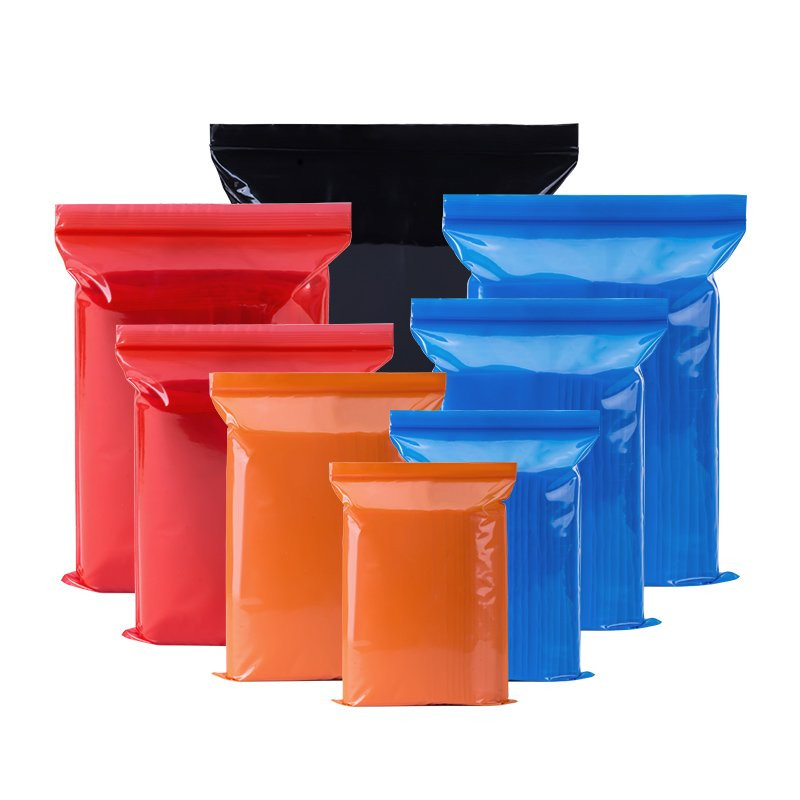 Red, orange, blue, and black colored ziplock bags in multiple sizes