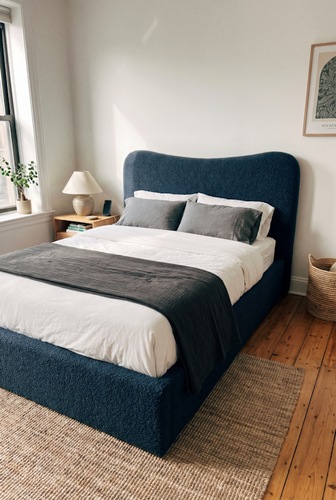 A curved headboard double ottoman bed that softens the geometry of a modern flat.png