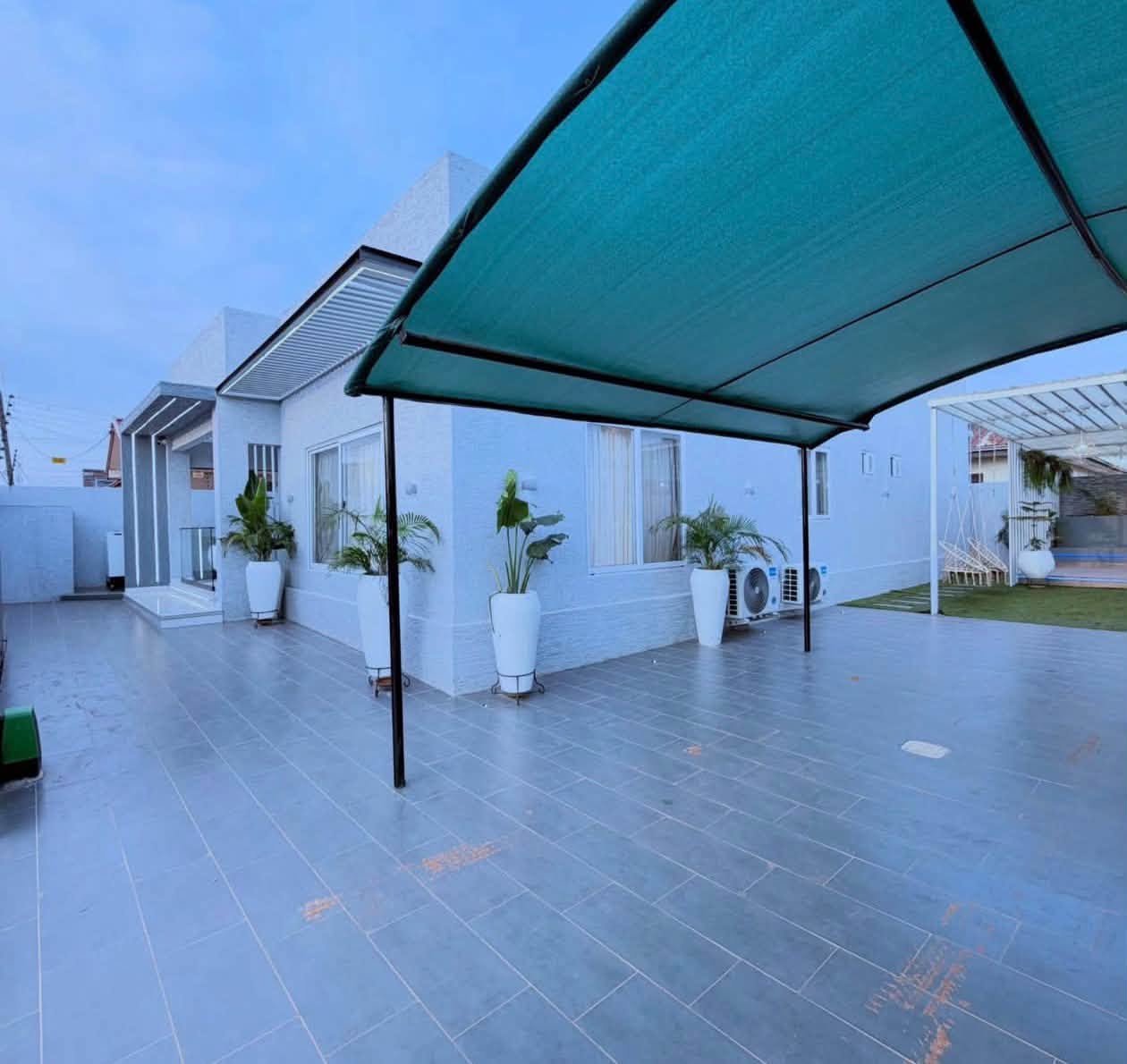 Luxury Contemporary Residential Estate - Expansive outdoor compound with shaded carport and garden landscaping