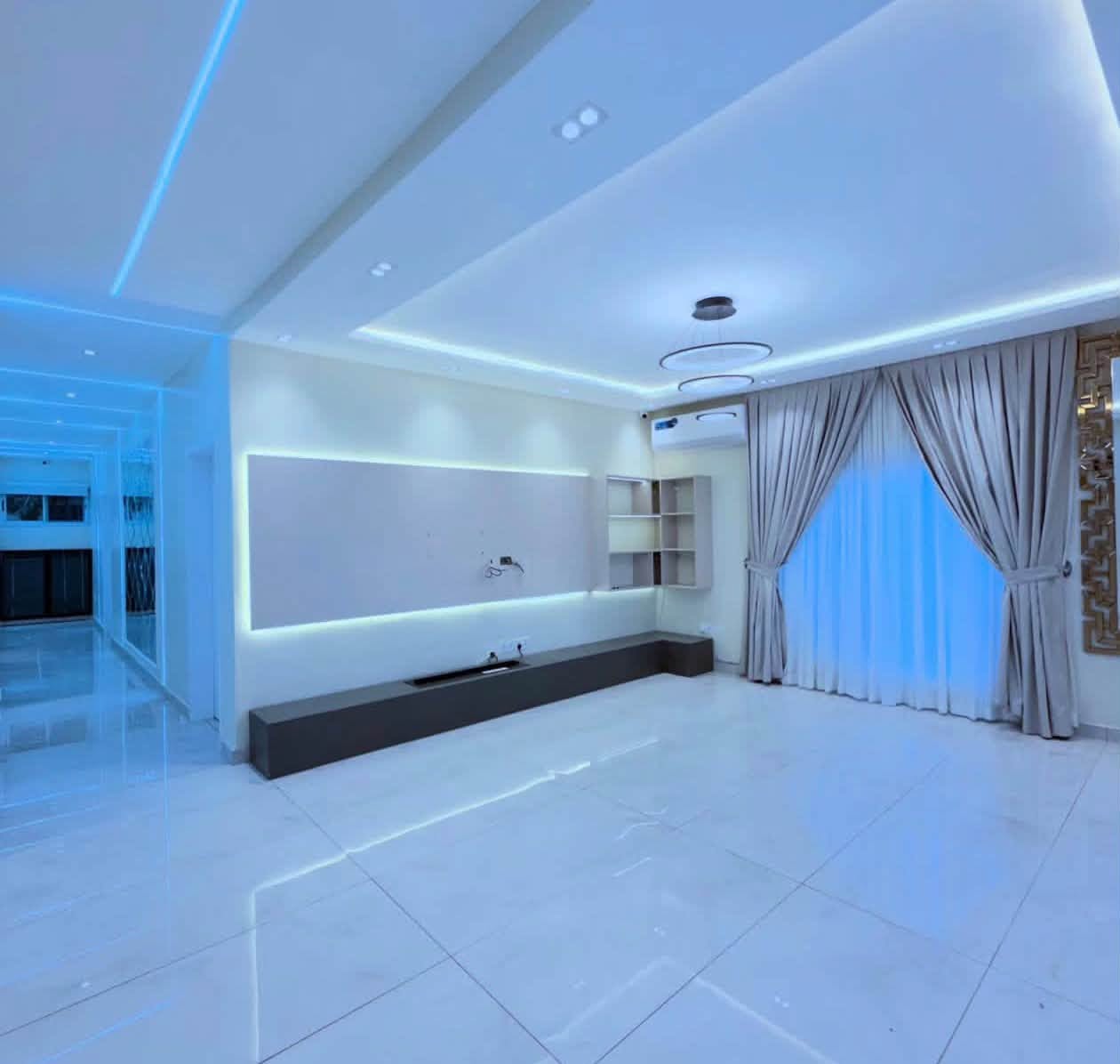 Luxury Contemporary Residential Estate - Elegant living room lounge with floating entertainment unit and cove lighting