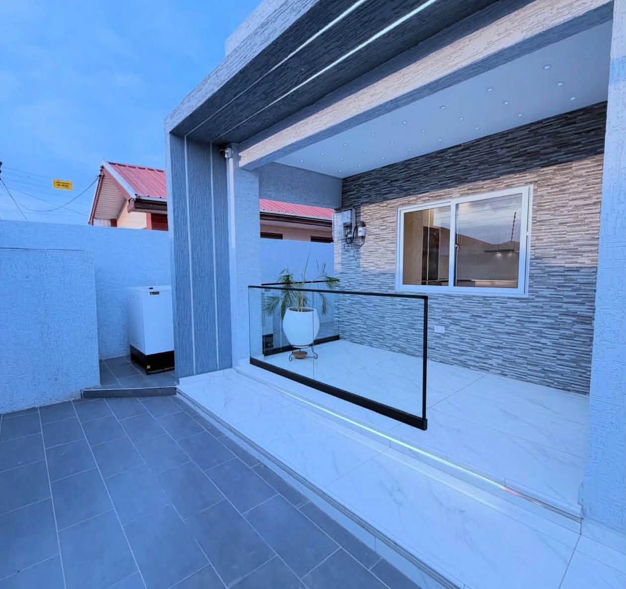 Luxury Contemporary Residential Estate - Covered outdoor sit-out terrace with glass balustrade and slate stone wall