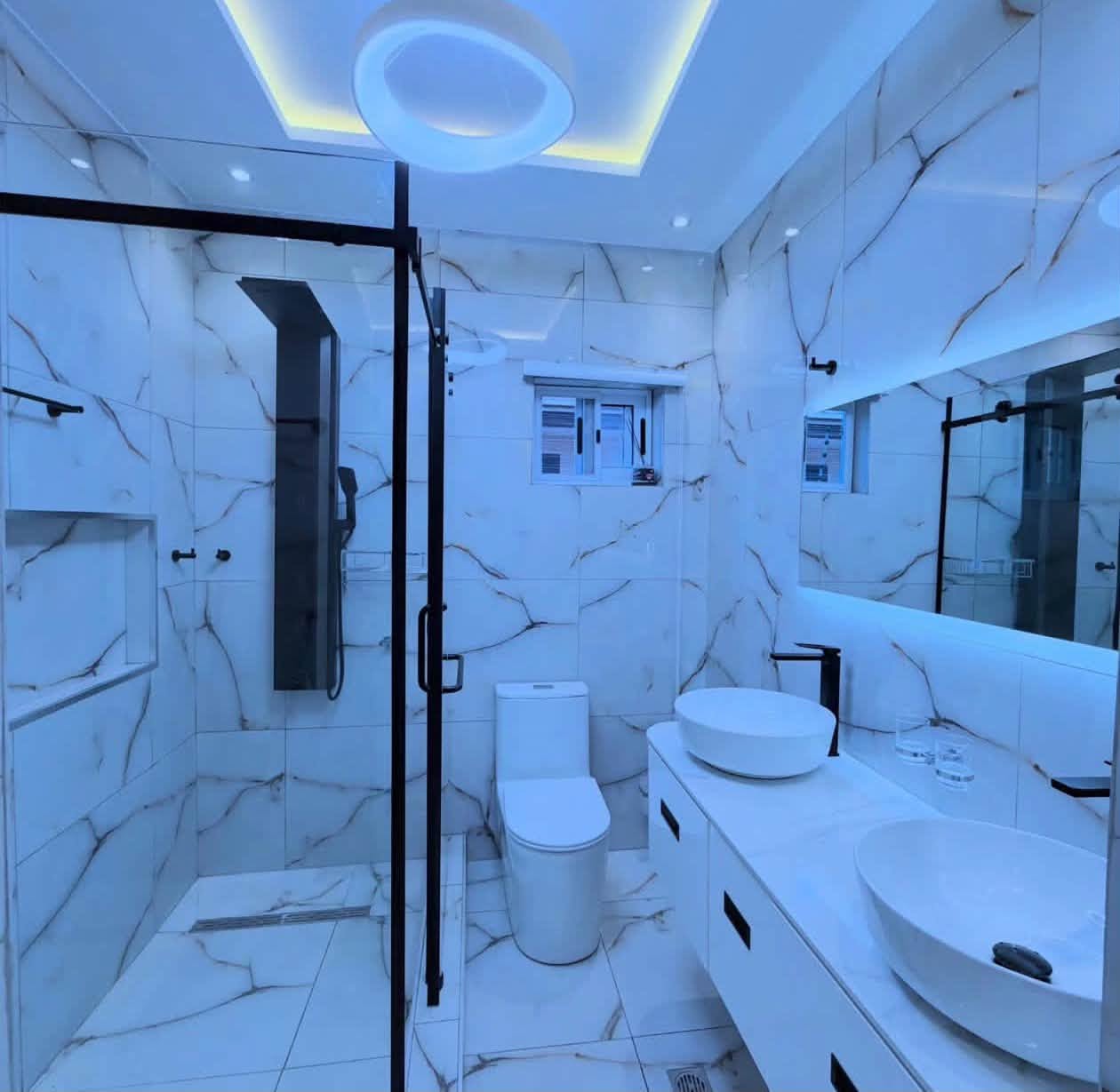 Luxury Contemporary Residential Estate - Spa-style master bathroom with marble tiling, double vanities, and glass shower