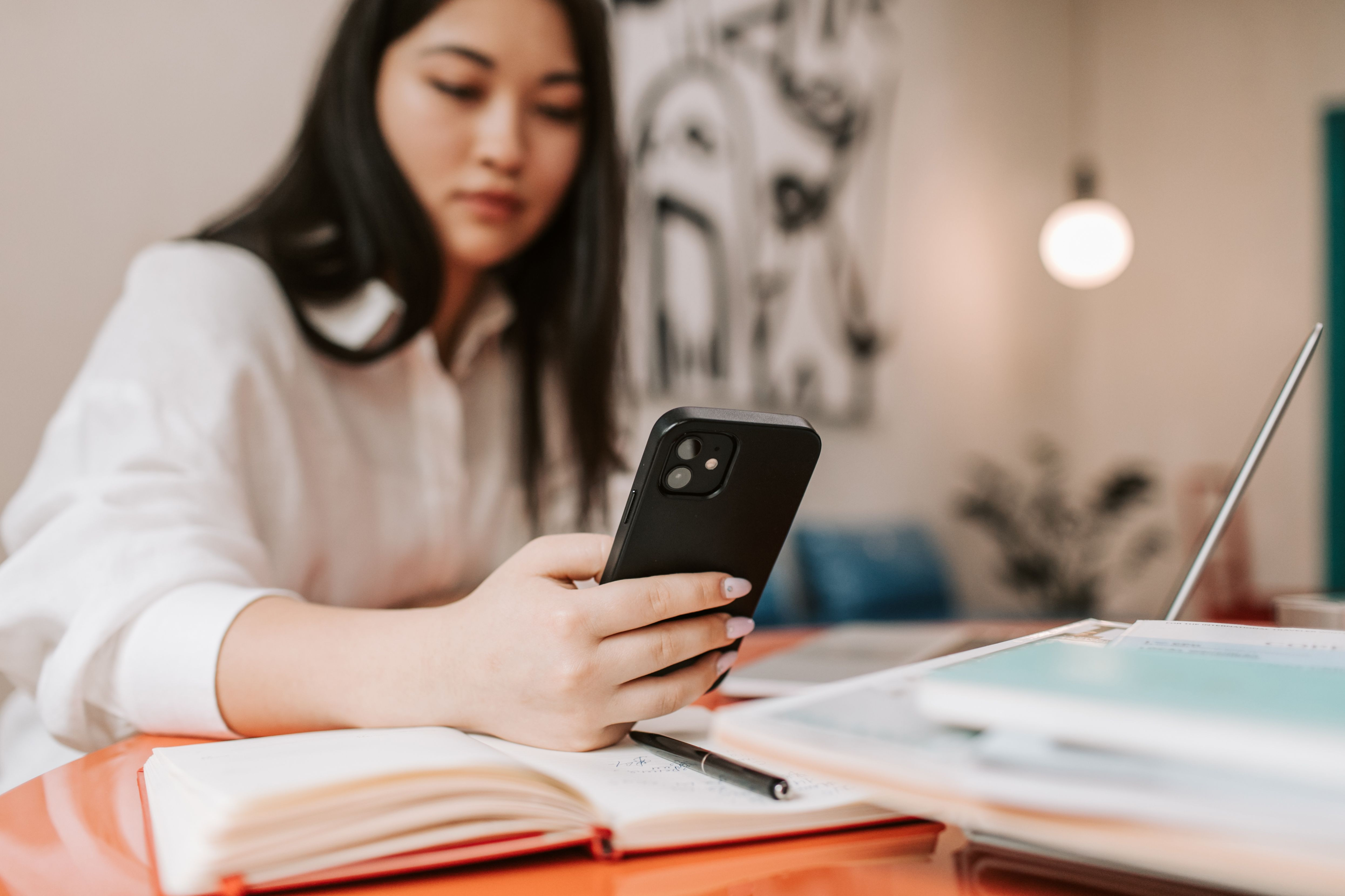 A person calmly using their phone in a bright, safe home setting