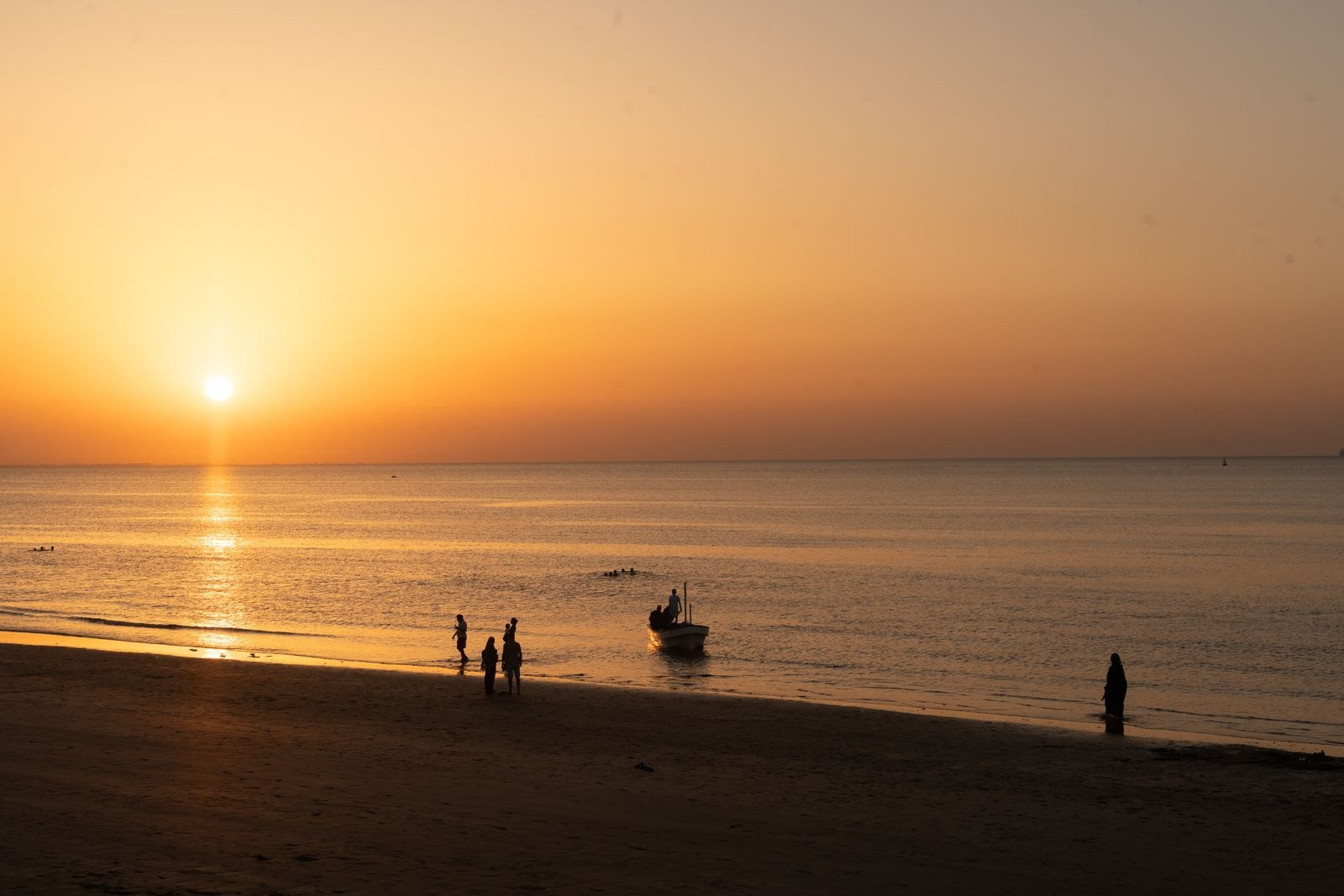 Sunset over a calm beach on the Muscat coastline