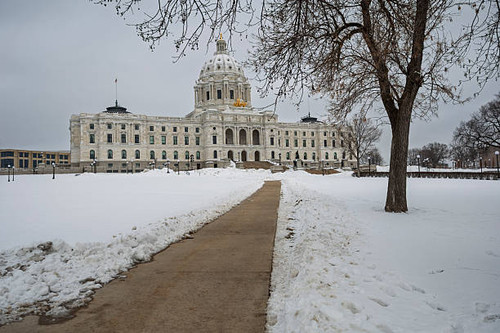 Minnesota State Capitol building with snow covering the grounds and a clear path leading to the entr.jpg