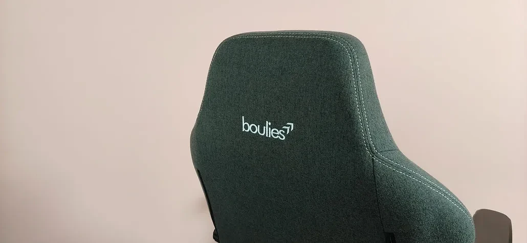 Close-up of back of headrests on Boulies Master Rex (2026), with pink wall in background