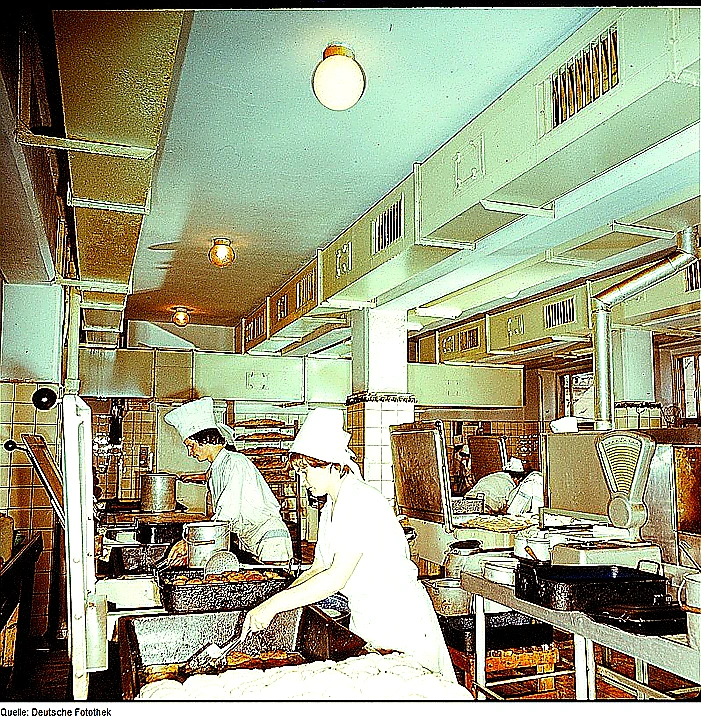 Bright colorful hero photo of a modern commercial kitchen with stainless equipment