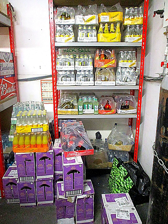 Sharp closing photo of organized commercial refrigeration and prep stations