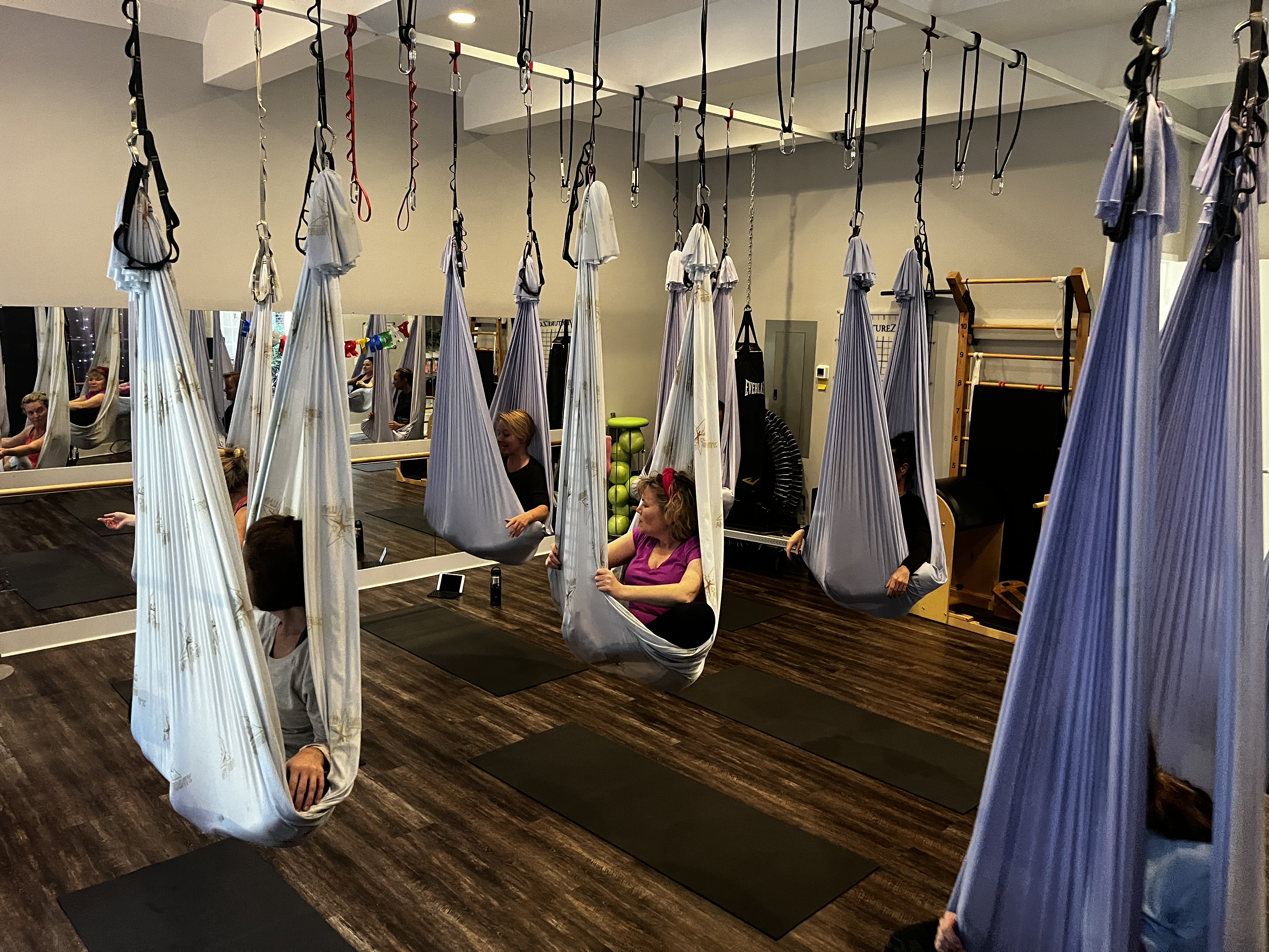 Anti-gravity fitness hammocks inside a Bluffton movement studio focused on movement and spinal decompression