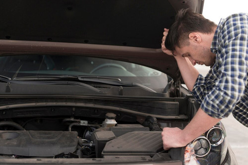 side view man trying repair car 23 2148514928.jpg