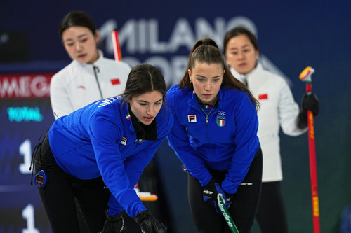 Italy's Stefania Constantini and Giulia Zardini Lacedelli in action during the women's curling round.jpg