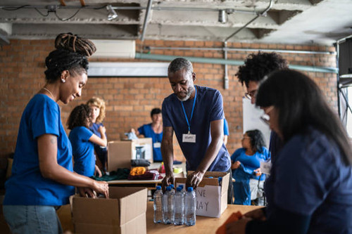 volunteers arranging donations in a community charity donation center.jpg