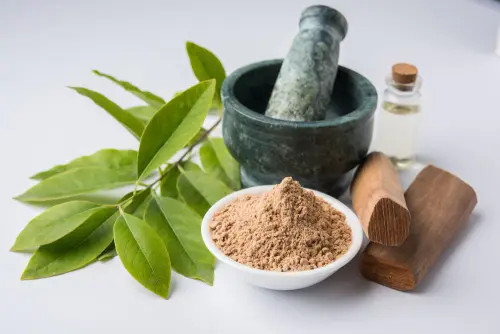 chandan sandalwood powder with sticks traditional mortar perfume oil miniature bottle green leaves s.webp
