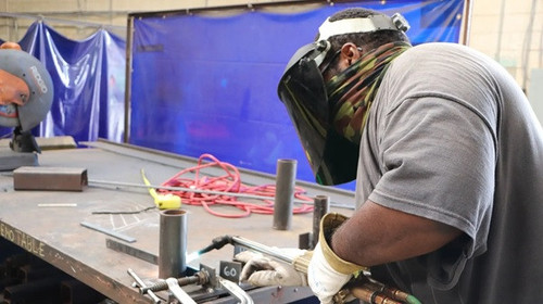 Expert pipe welder applying clean accurate seams to industrial pipes 1.jpg