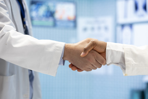 medical staff doing handshake end cabinet meeting.jpg