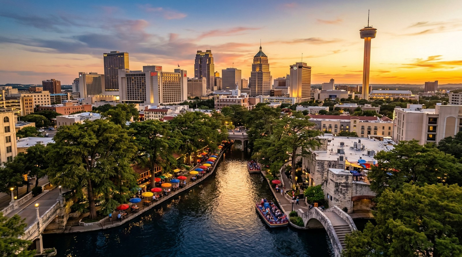 San Antonio River Walk at sunset with downtown skyline and Tower of the Americas