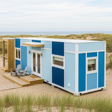 Vertical Pintereststyle image of container home with coastalinspired blue palette Centered overlay t