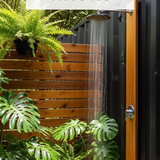 Vertical Pintereststyle image of container home with outdoor shower Centered overlay text reads Outd