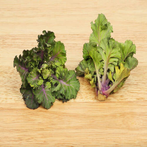 Two  fresh Kale sprouts on a wooden board.jpg