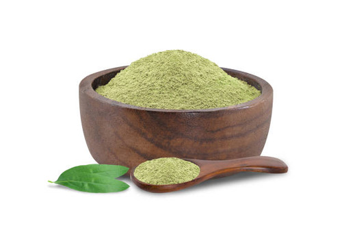 Andrographis Paniculata powder in the wooden bowl and green leafs isolated on white background.With .jpg