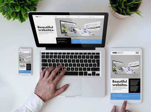 office tabletop with tablet, smartphone and laptop showing cool responsive design website.jpg