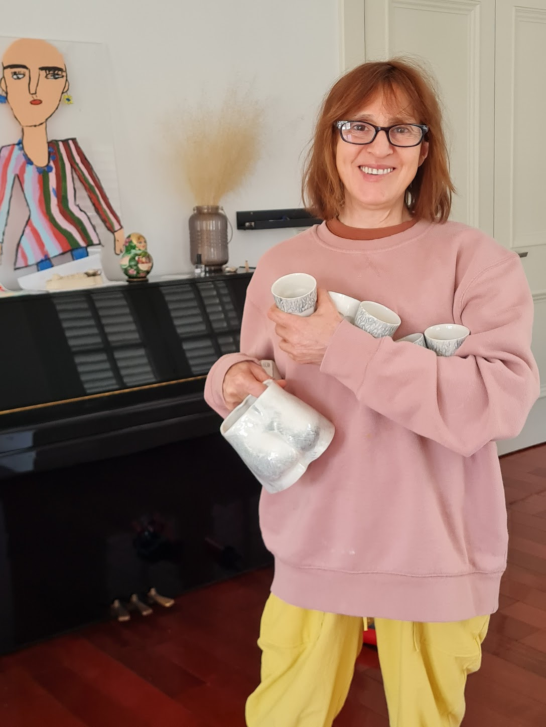 Mom holding her ceramic cups and vases