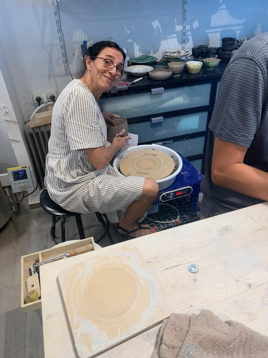 Mom at the pottery wheel in her studio
