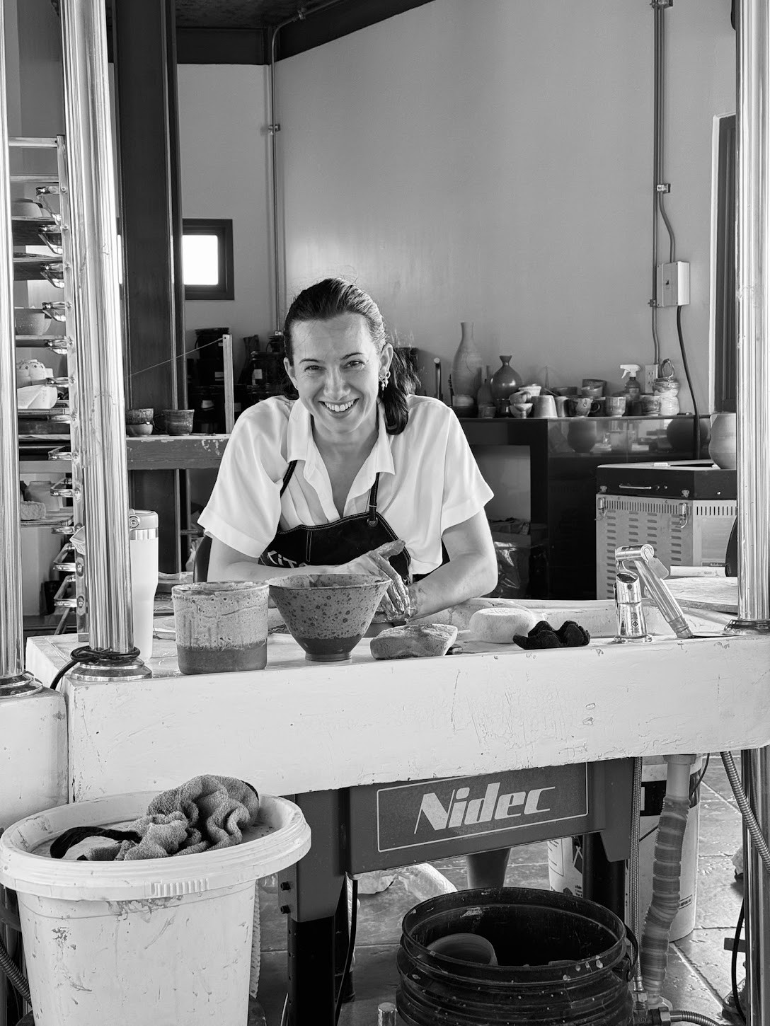 At the studio workbench with ceramic pieces
