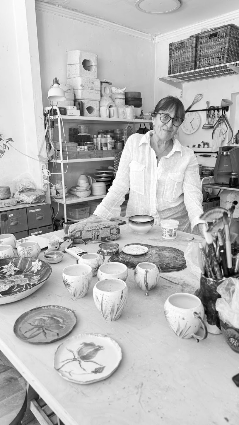 Mom in her studio surrounded by finished ceramics