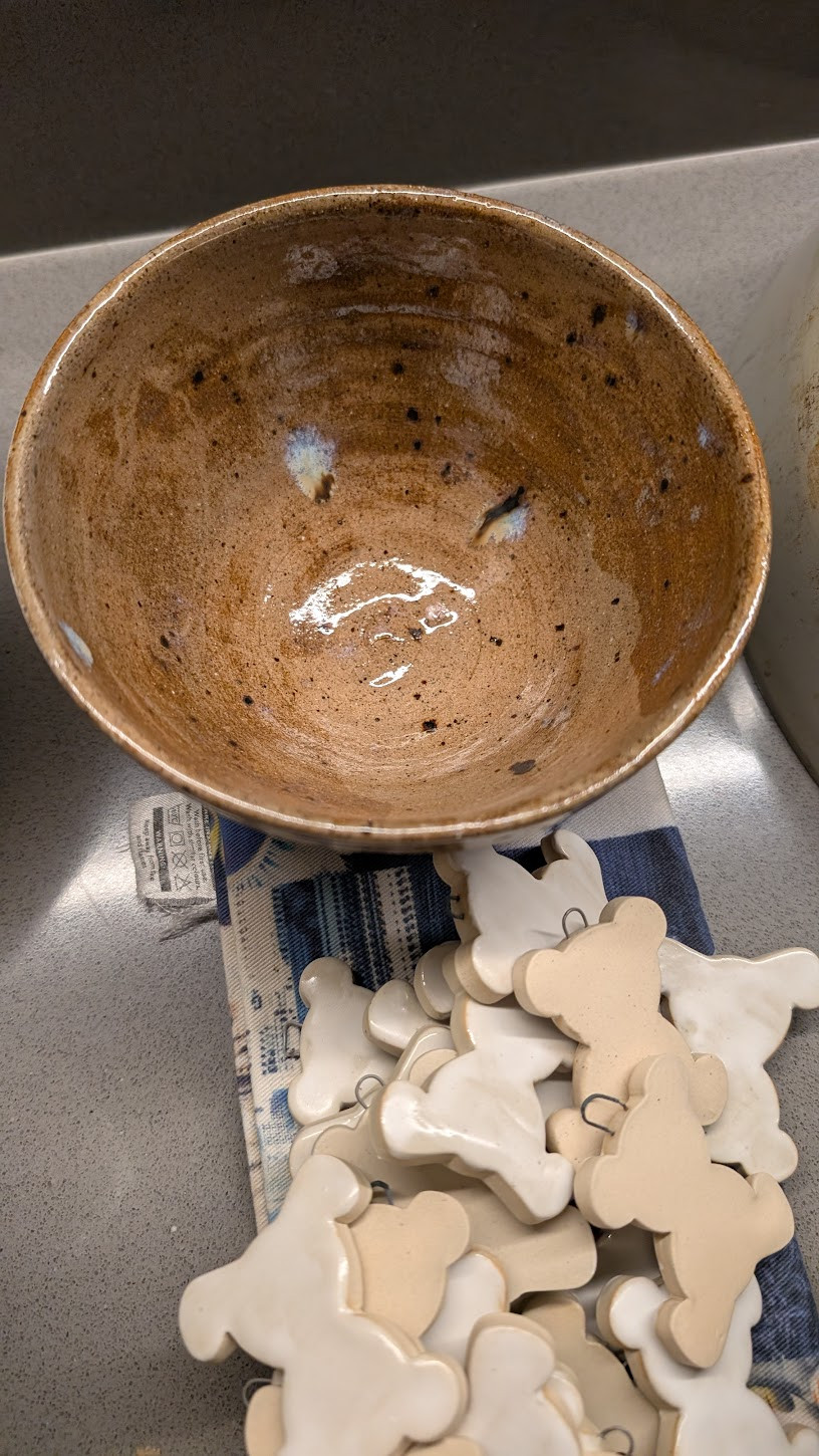 Speckled brown bowl with bisque porcelain pendants