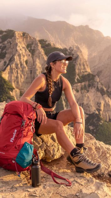 Golden Hour Adventure: A Hiker’s Peaceful Moment Above the Mountains