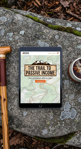 110 Overhead view of a tablet showing an affiliate bridge page a topographical map a wooden walking .jpg