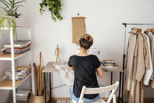 back view female tailor working studio