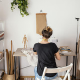 back view female tailor working studio