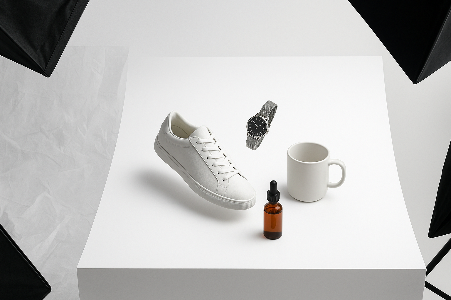 An overhead view of a minimalist tabletop photo studio. A sneaker, watch, serum bottle, and ceramic mug hover above a seamless pure-white sweep with soft, diffused lighting. On the left, faint ghosted "before" cutouts show messy wrinkled backdrops; on the right, immaculate #FFFFFF results with razor-clean edges and a soft, realistic contact shadow under each product. Modern commercial aesthetic, hyperrealistic, no text, 85mm lens depth-of-field, studio flags and softboxes visible at the periphery.