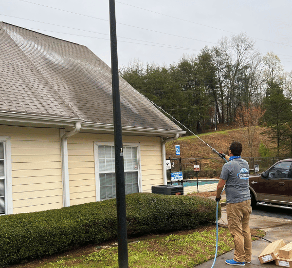 Southern Exterior Cleaning crew performing soft wash roof cleaning on a North Georgia home
