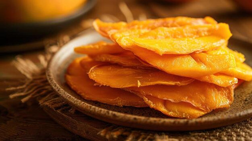 a plate of dried mango slices arranged neatly showcasing their vibrant color and texture photo.jpg