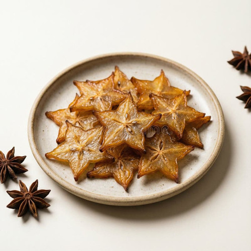 dried starfruit plate jpg golden brown slices arranged ceramic against light background glossy star .jpg