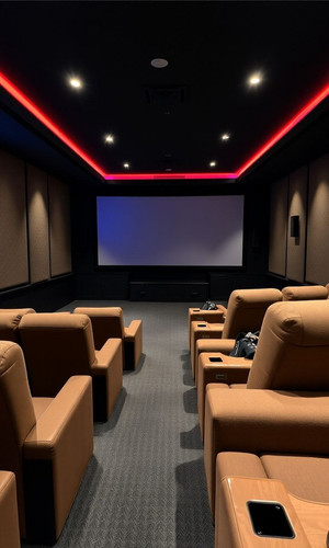 private movie theater with plush seats and a massive screen.jpg