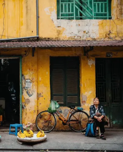 Woman sat on Hanoi sidewalk.webp